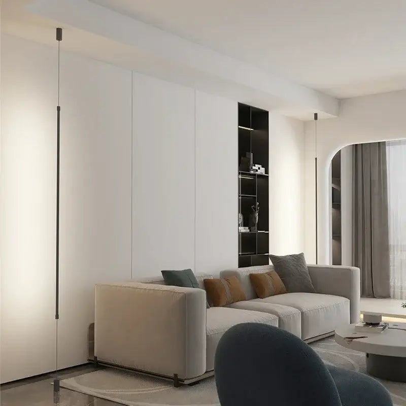 Beige upholstered sectional sofa with gray and brown pillows under decorbites black led pendant light for modern decor