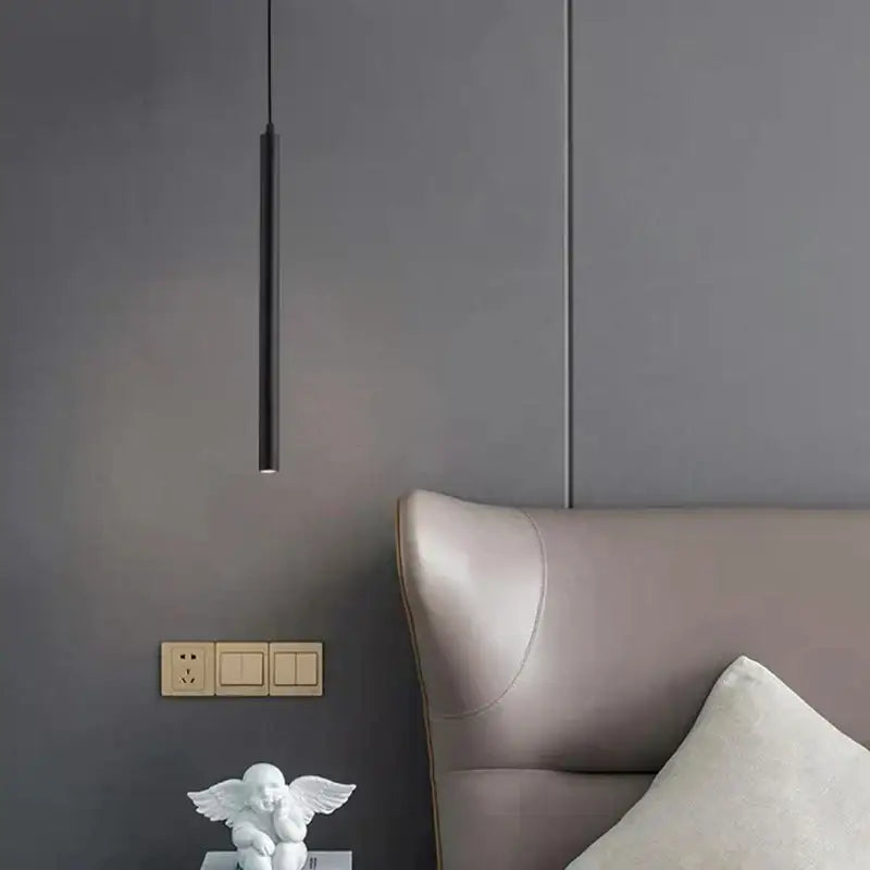 Black led cylindrical pendant light from decorbites hanging above bed with sleek minimalist design for bedroom use