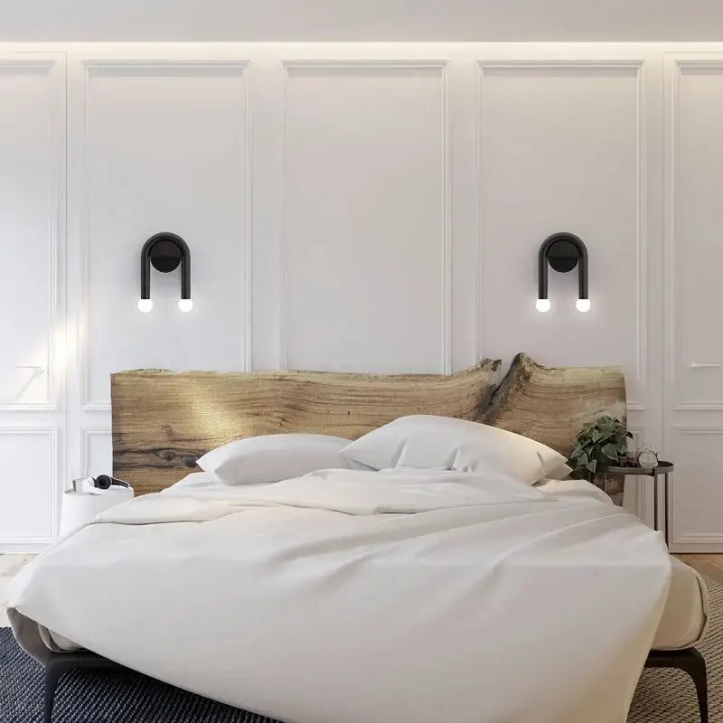 The decorbites black led wall lamp features a modern nordic design paired with a rustic natural wood headboard