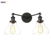DecorBites black led wall sconce with two black wrought iron arms and clear glass bell-shaped shades for bedroom bathroom mirror