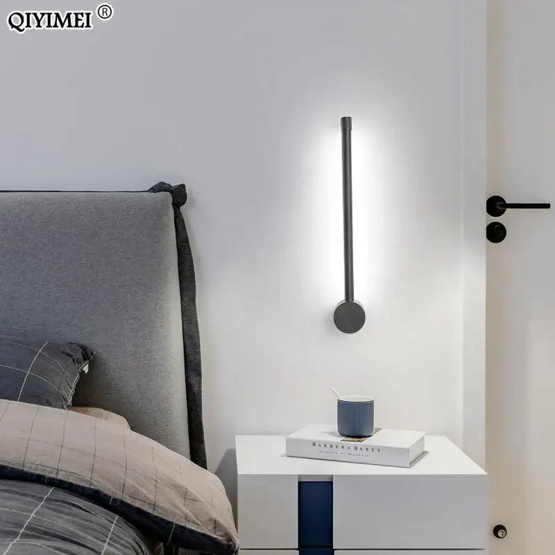 Modern minimalist decorbites black led wall sconce with sleek black metal cylindrical design emitting soft white light