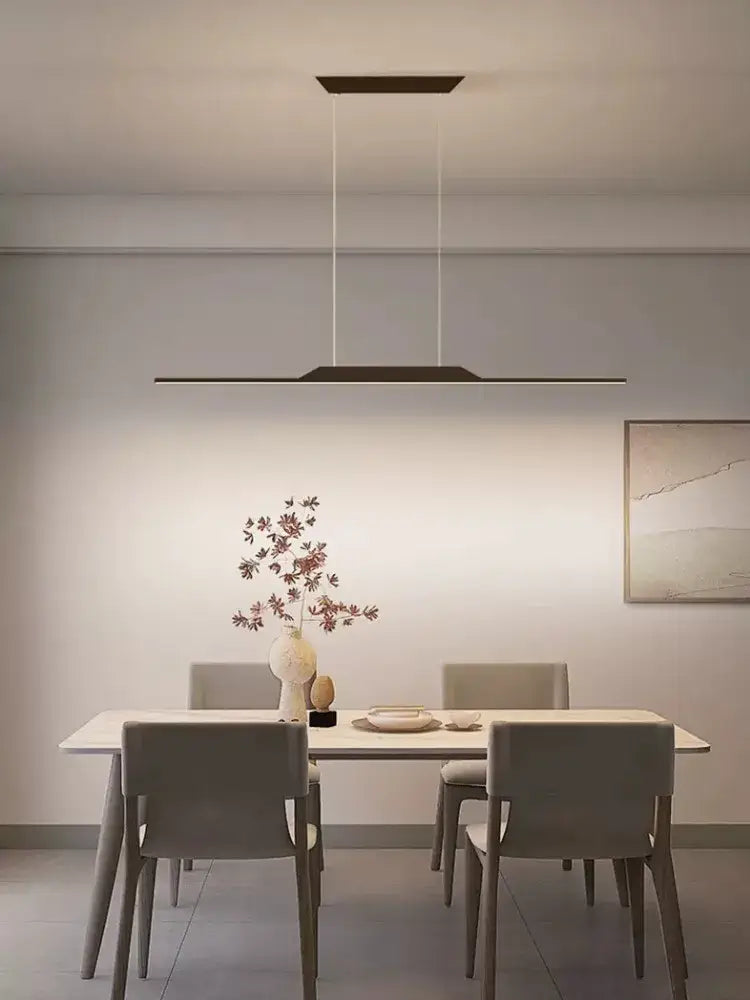 Modern minimalist black line chandelier by decorbites with thin cables hanging above a dining table for luxury lighting
