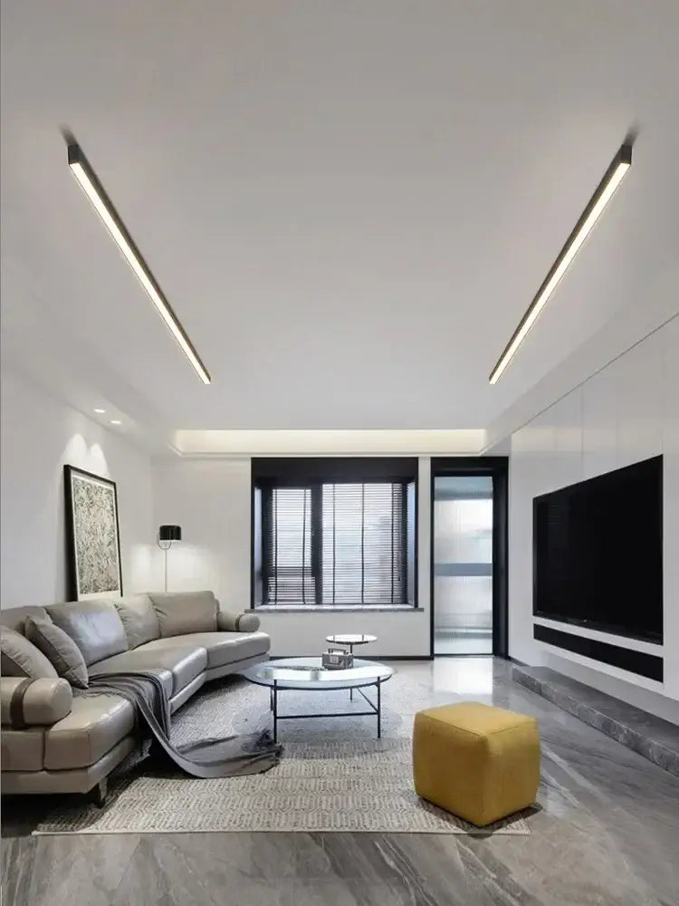 Yellow upholstered cube ottoman displayed under decorbites black linear led ceiling lamp for living room and dining area