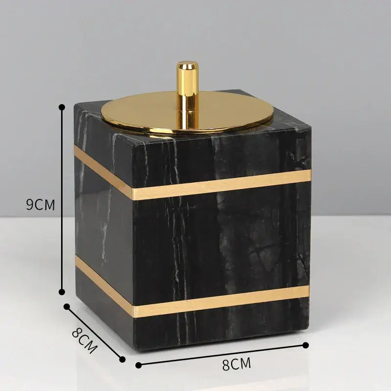 Decorbites black marble cube bathroom accessory with gold-toned lid and sleek horizontal bands for marble bathroom use