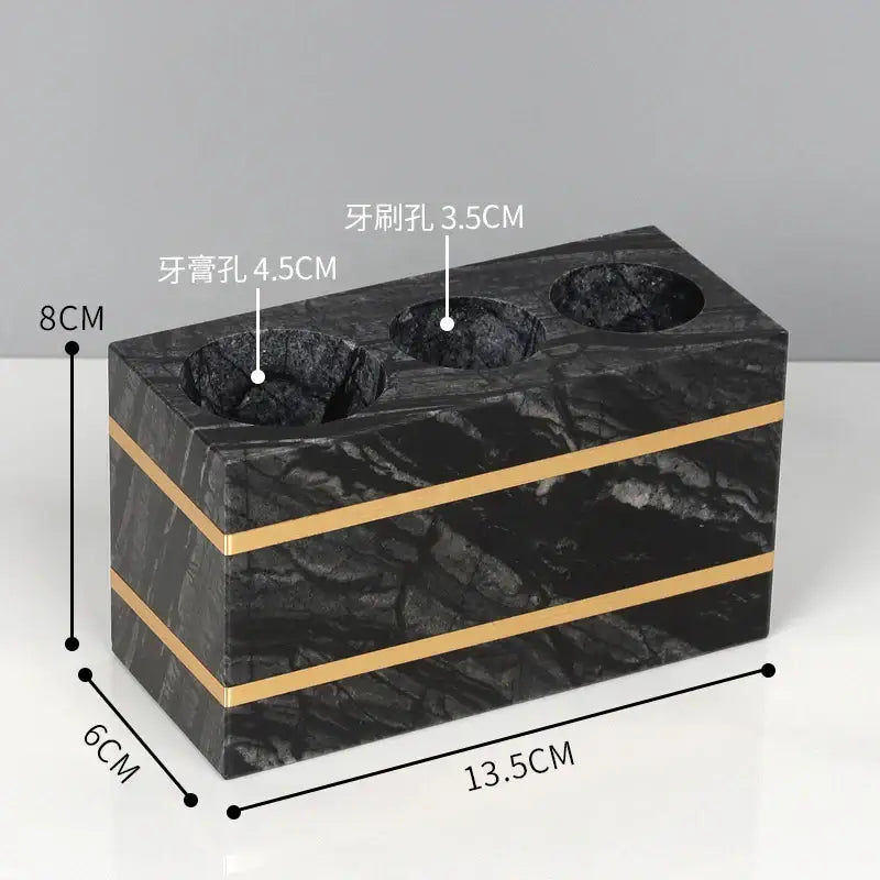 Decorbites black marble toothbrush and toothpaste holder with gold accent stripes for black marble bathroom accessories