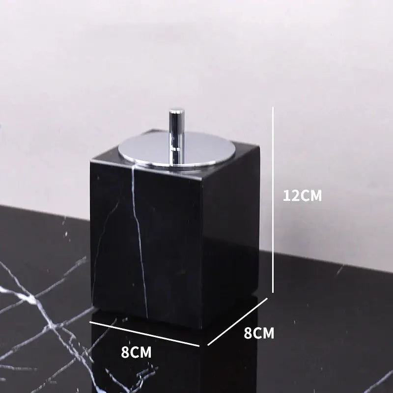 Black marquina cube-shaped toothbrush holder with sleek chrome lid and central stem from decorbites black marquina bathroom set