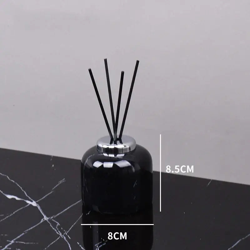 Black glass reed diffuser with silver metallic cap and five black reeds from decorbites black marquina bathroom set