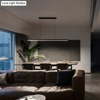 DecorBites™ black metal linear LED pendant light with remote control suspended above dining table