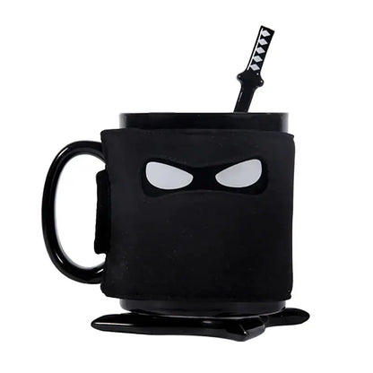 Decorbites black ninja mug with matte finish white eye cutouts and matching black sword stirrer kitchen novelty cup