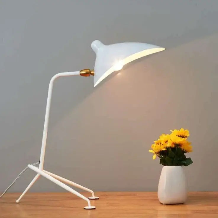 White desk lamp with sleek curved arm and tripod base contrasted with decorbites black nordic floor lamp in living room
