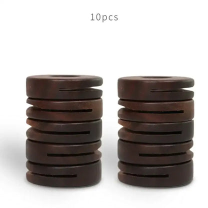 Dark brown wooden coil springs stacked in two piles for decorbites black walnut donuts bag clips kitchen sealing tool