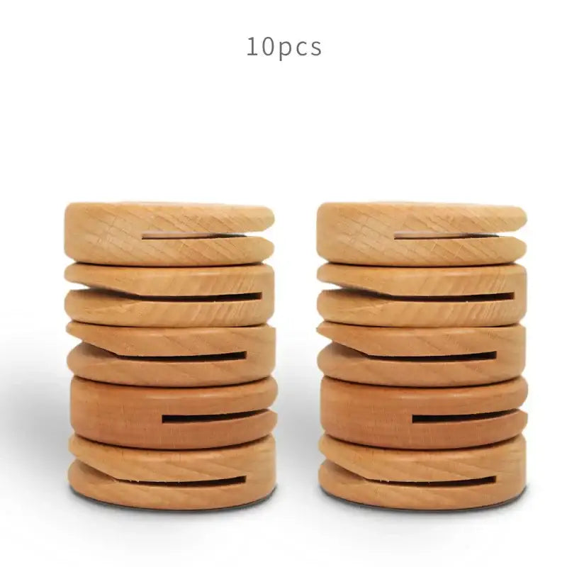 Two stacks of decorbites black walnut donuts bag clips in light brown wood with central slit and visible wood grain