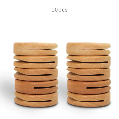 Two stacks of decorbites black walnut donuts bag clips in light brown wood with central slit and visible wood grain
