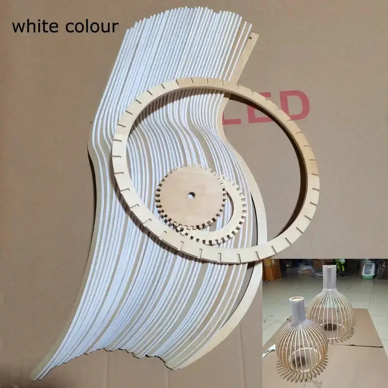 White wooden wall art with layered curved slats and central gear design complementing decorbites black wood cage chandelier