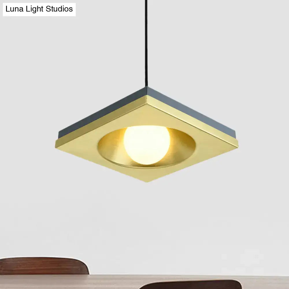 DecorBites™ blue and gold modernist pendant light with square brass frame dark gray accents and illuminated bulb base