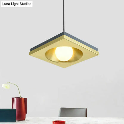 DecorBites™ pendant light with brushed gold finish, dark gray metal squares, and illuminated bulb base for bedrooms