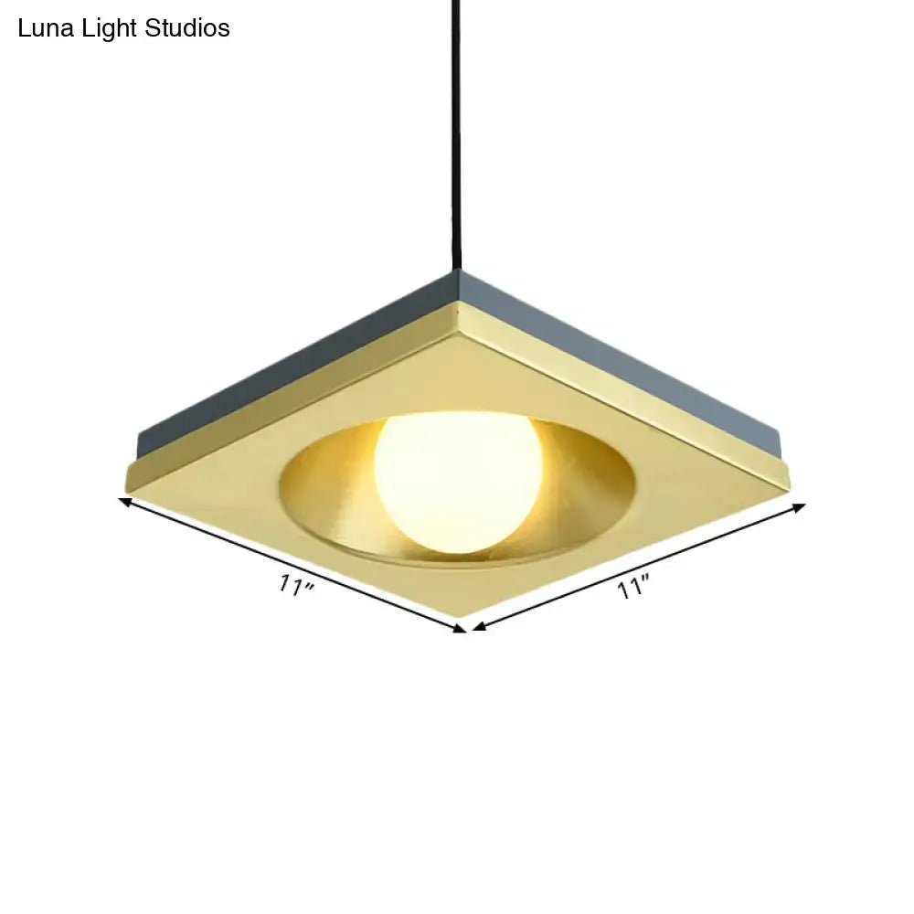DecorBites™ pendant light with brushed brass square frame, dark gray edges, and warm-toned bulb base for bedrooms