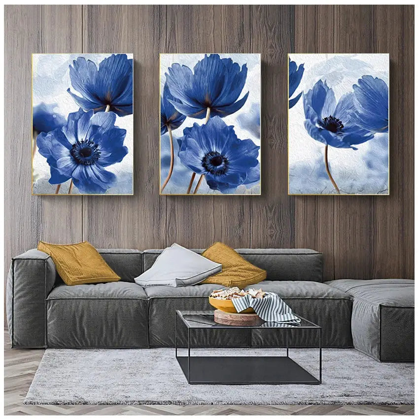 Three-panel set of framed blue flowers artwork with textured brushstrokes in gold-toned frames for living room decor