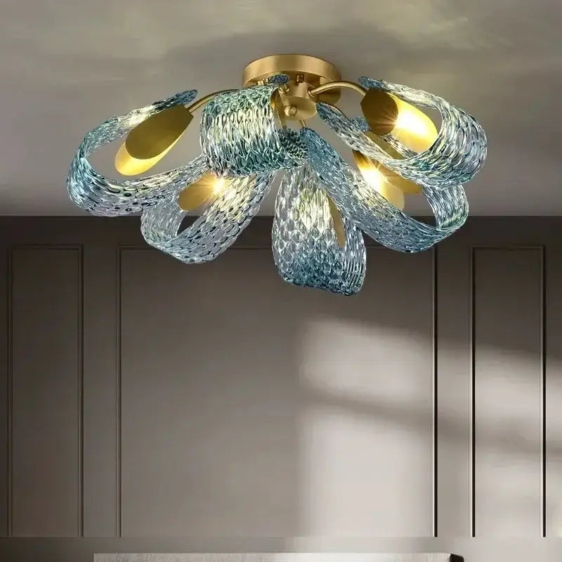 DecorBites blue glass led pendant lamps featuring a blue glass chandelier with gold accents and woven texture