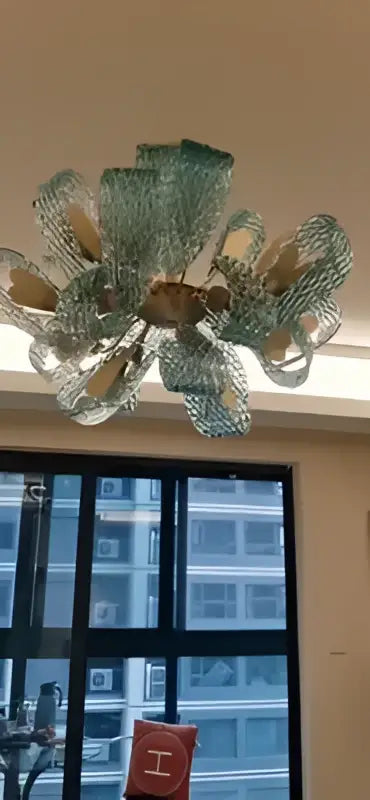Decorbites™ blue glass led pendant lamps feature a translucent green glass chandelier with floral design and golden accents