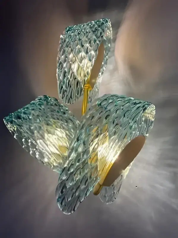 A modern three-leaf decorbites™ pendant lamp with translucent teal blue glass led petals and a gold-toned stem