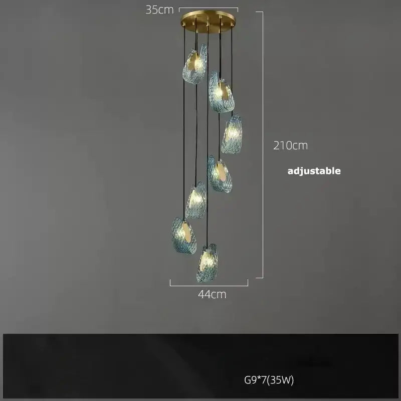 A modern DecorBites™ blue glass LED pendant lamp with seven adjustable iridescent orbs and brass-finished base