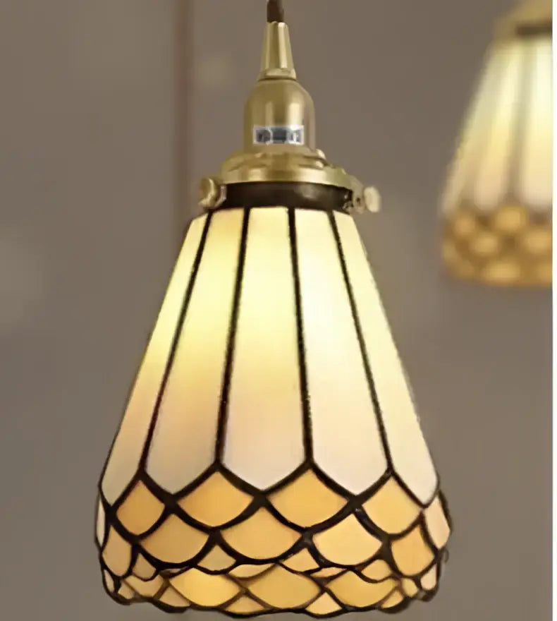A warm amber-tinted stained glass pendant light with brass frame and scalloped petals for decorbites blue glass