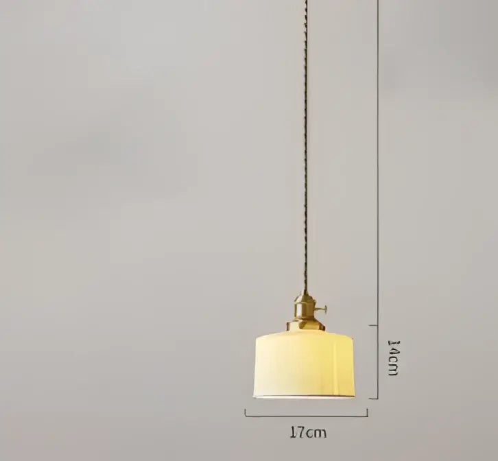 A warm pendant light with a textured fabric shade and brass hardware complements the decorbites blue glass pendant