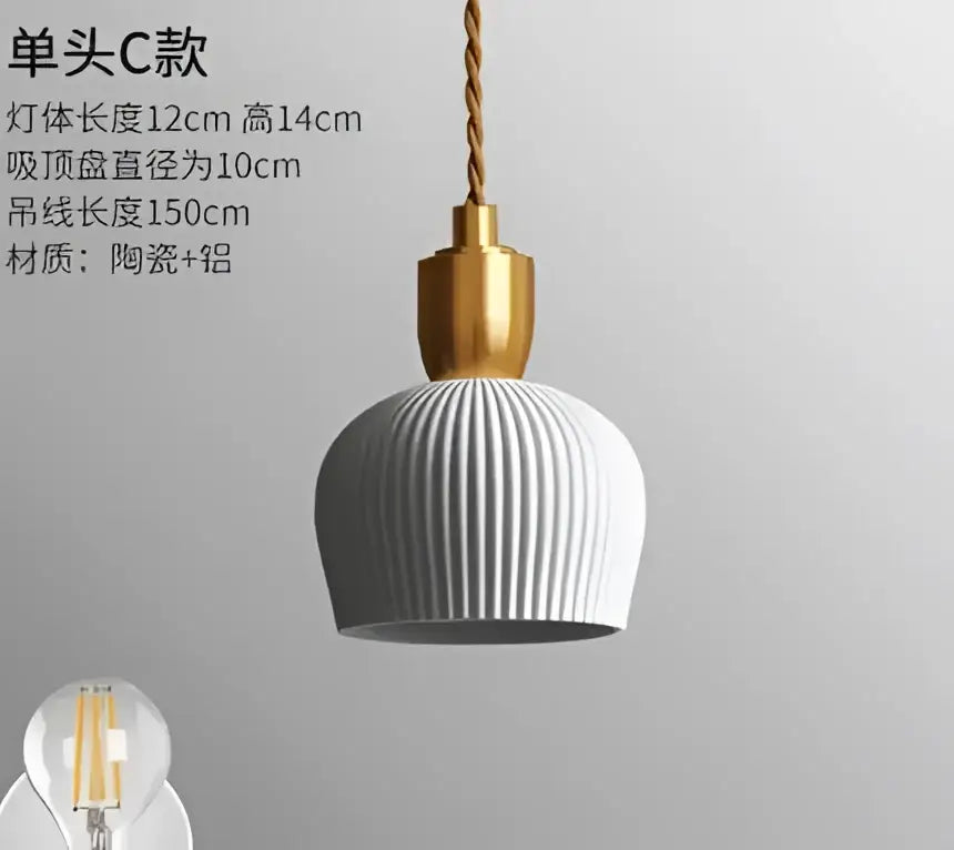 A modern pendant light with a ribbed matte gray ceramic shade and polished brass fixture for dining room lighting