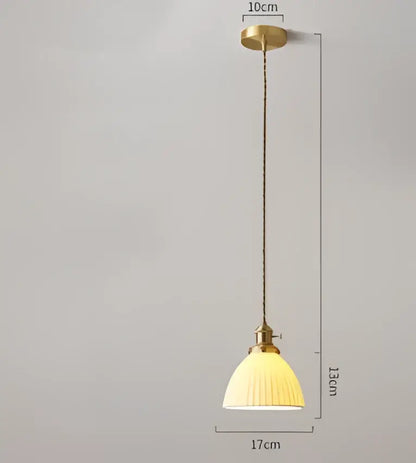 A vintage-style pendant light with brass frame and cream ribbed shade for dining room by decorbites blue glass pendant lights
