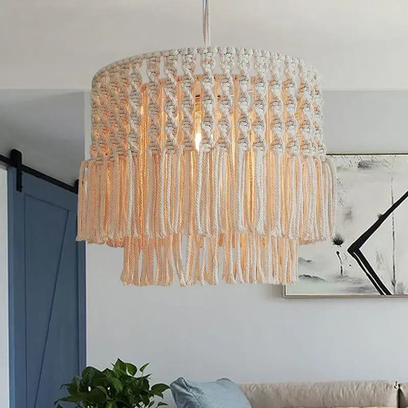 Cream-colored bohemia cotton rope chandelier with tiered woven design and hanging fringe for dining room or balcony