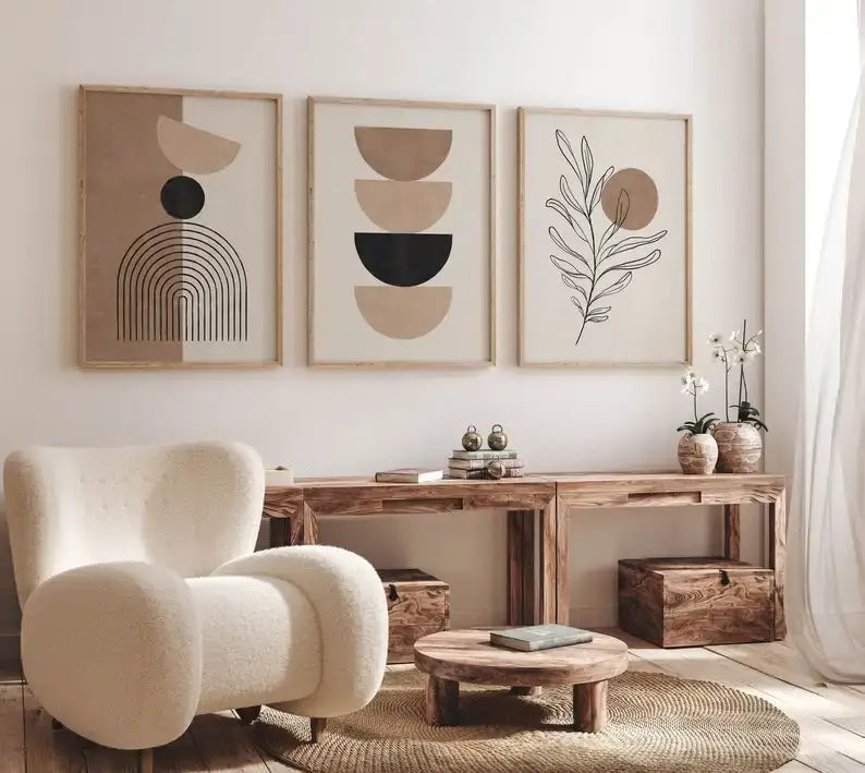 Cream-colored plush armchair with rounded contours and wooden legs next to decorbites™ bohemian geometric plant wall art set