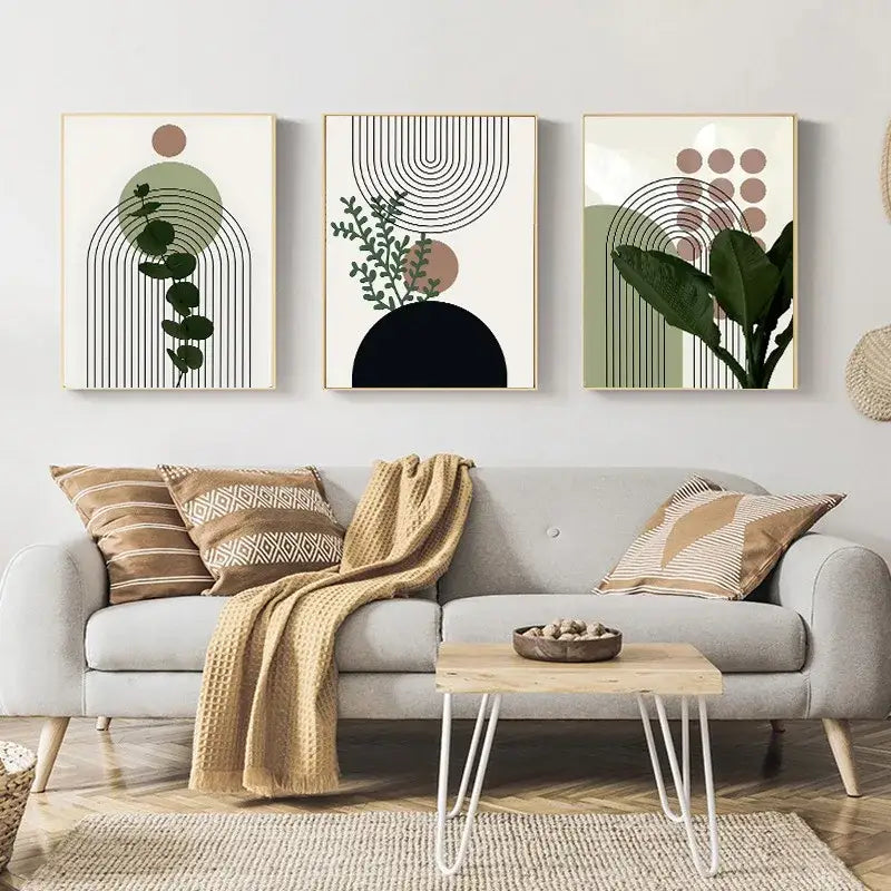 Set of three DecorBites™ bohemian light wall art pieces featuring green leaves in muted tones on natural wood frames