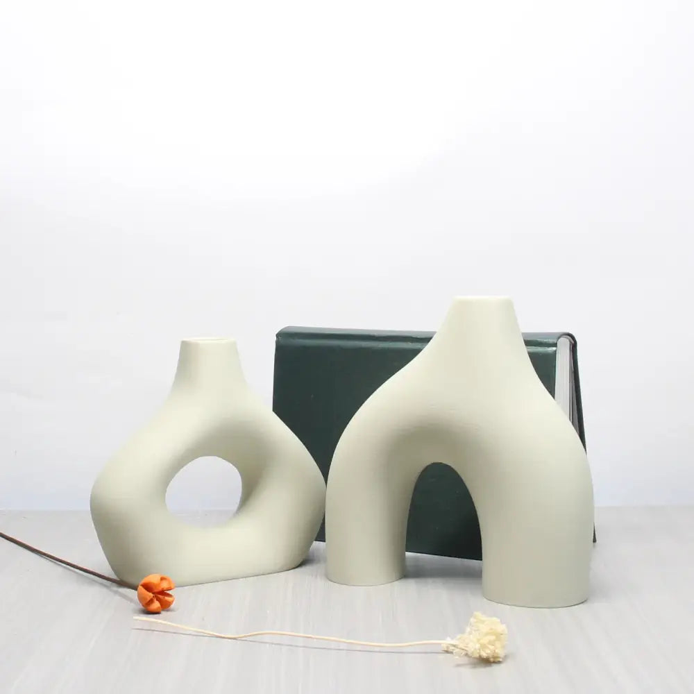 Cream-colored ceramic vase set with abstract organic shapes and smooth matte finish for bohemian home decor
