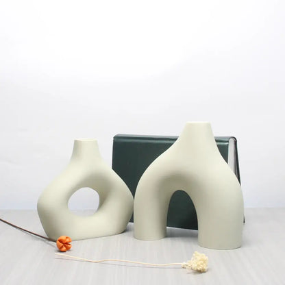Cream-colored ceramic vase set with abstract organic shapes and smooth matte finish for bohemian home decor