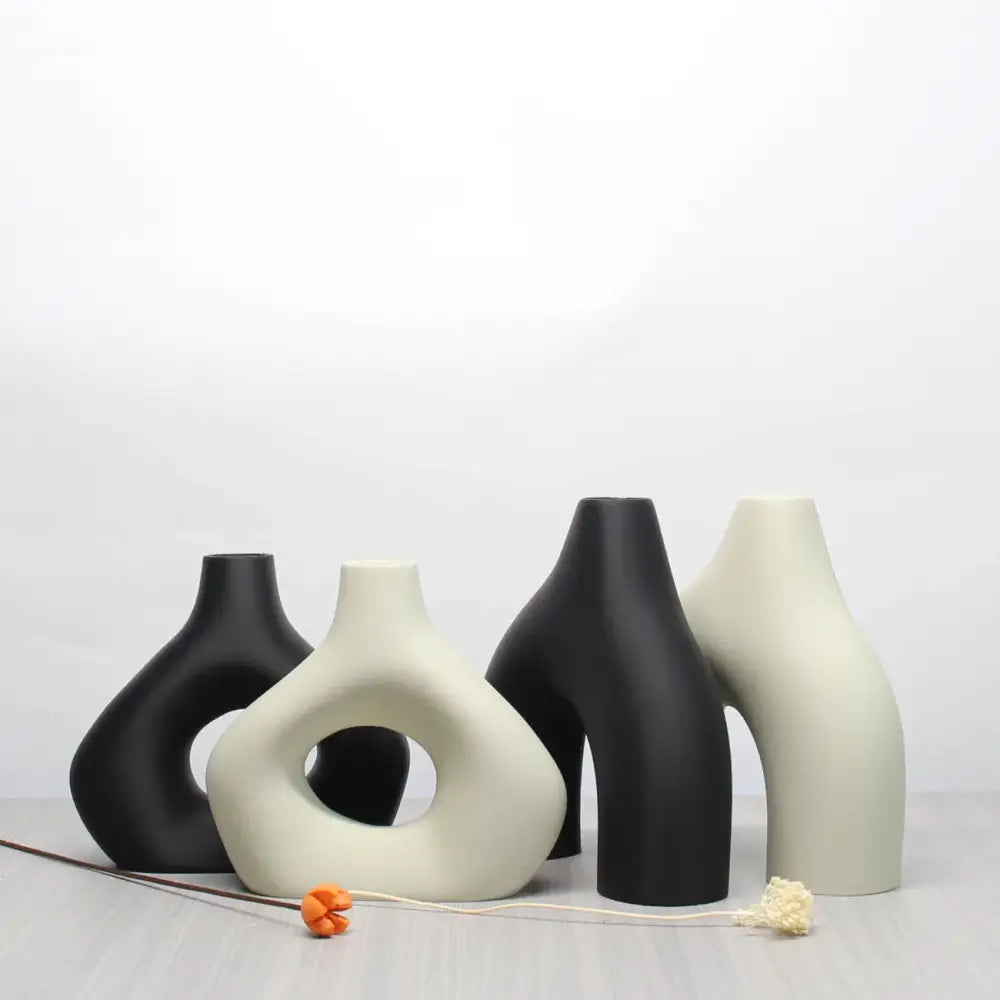 Set of four minimalist black and off-white ceramic vase set with abstract shapes for bohemian home decor