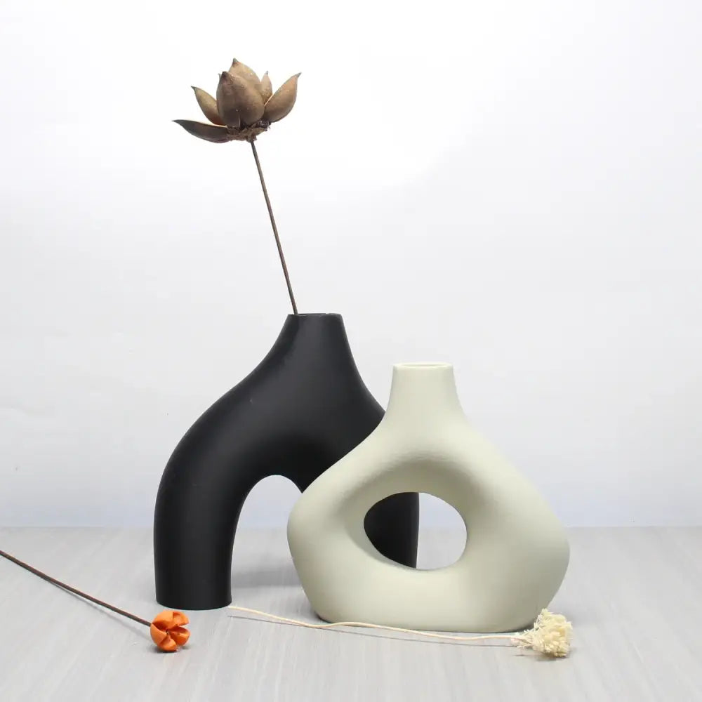 A sleek matte black ceramic vase from decorbites™ bohemian home decor vase set with arched opening and smooth curves