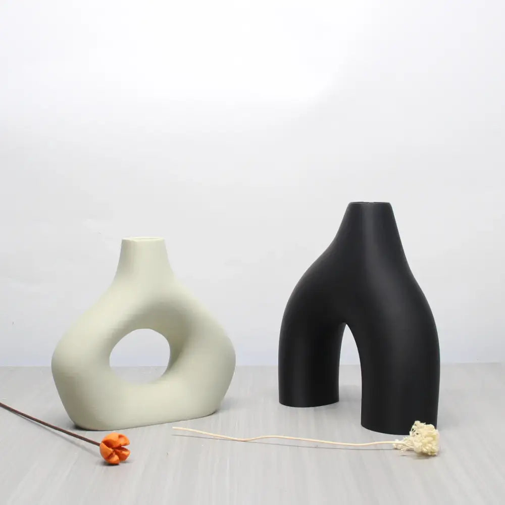 Two minimalist ceramic vases in a bohemian home decor vase set featuring matte off-white and glossy black finishes