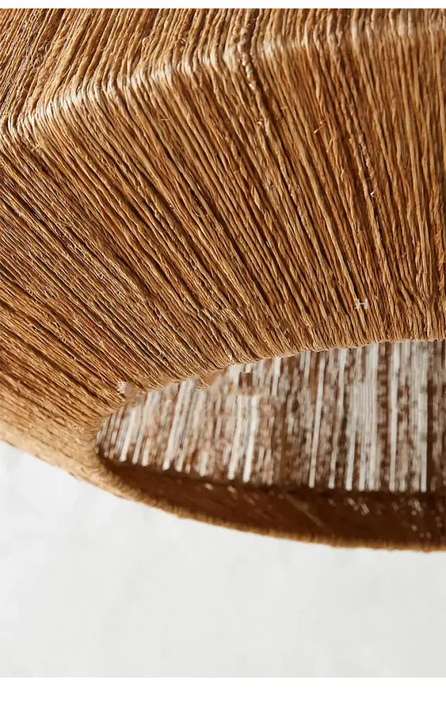 A woven light brown paper lampshade with ribbed texture in the decorbites bohemian rattan chandelier tiered bamboo light