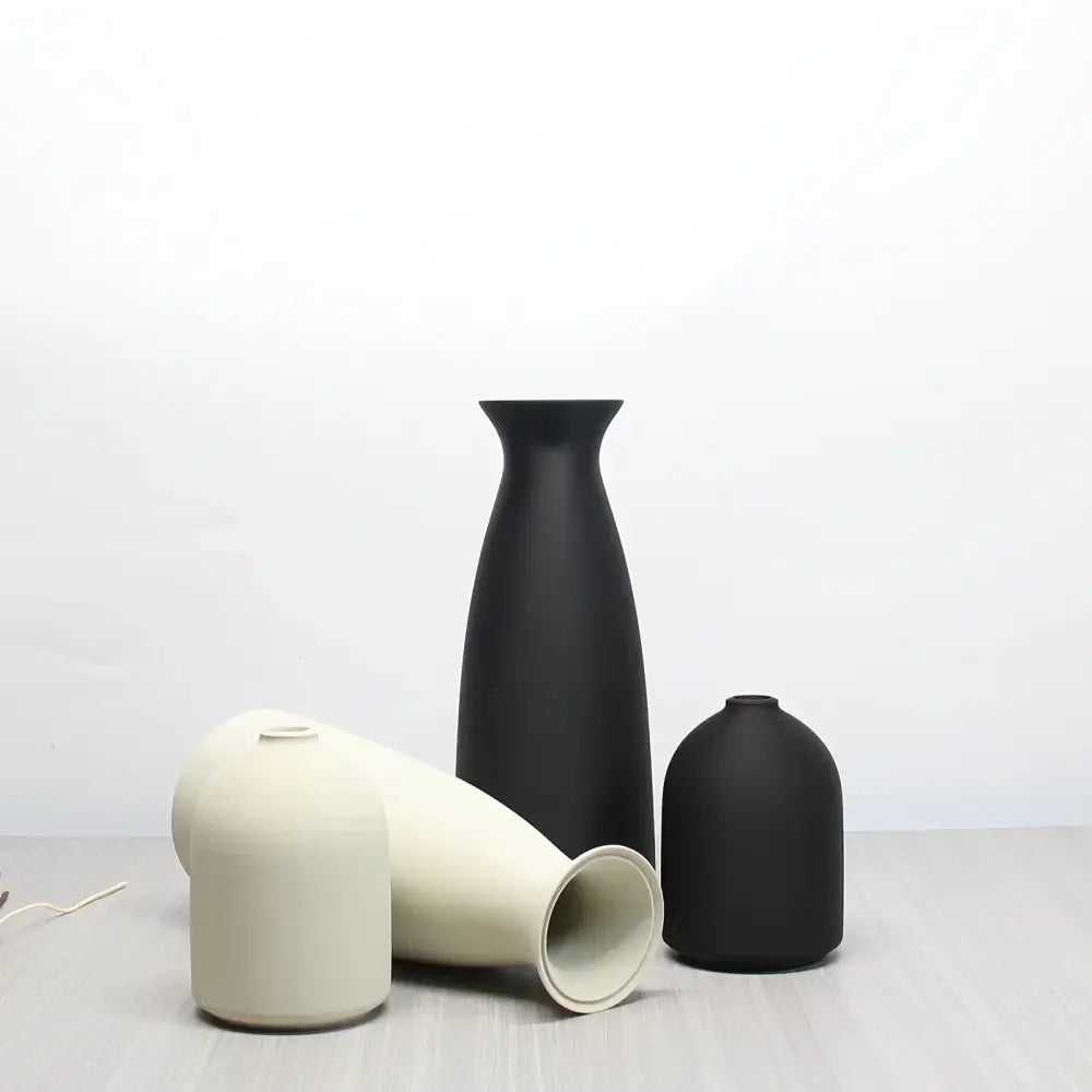 Minimalist matte black and off-white ceramic bohemian style decorative vase set with sleek modern silhouettes by DecorBites