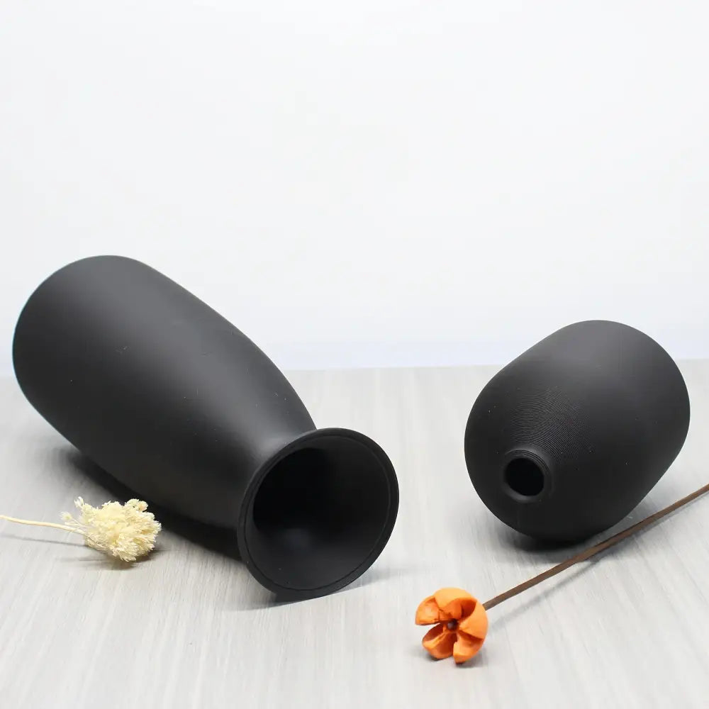 Two matte black ceramic vases including elongated and rounded shapes in the decorbites bohemian style decorative vase set