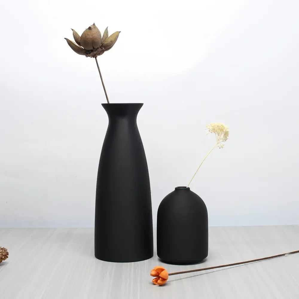 DecorBites™ bohemian style decorative vase set of two matte black ceramic vases with dried lotus pod and white flower