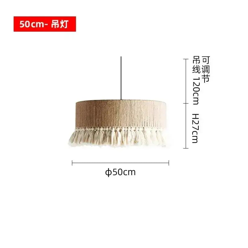 A beige cylindrical decorbites bohemian tassel chandelier with textured fabric and white tassels for bedroom lighting