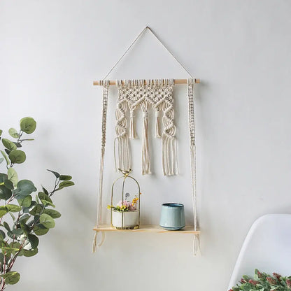 Beige macrame hanging shelf with wooden dowel tassels and integrated shelf for decorative items wall shelf home decor
