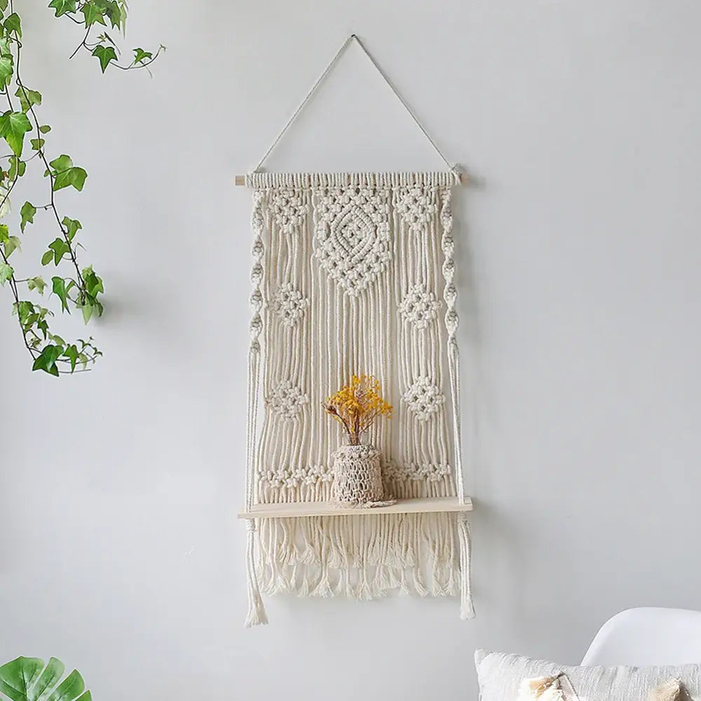 Cream-colored creamab macrame wall shelf with woven wood shelf and decorative fringe for stylish home decor hanging shelf