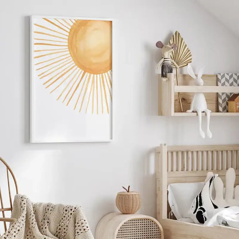 A framed DecorBites™ boho rainbow sunshine nursery poster featuring a watercolor sun with golden rays on white background