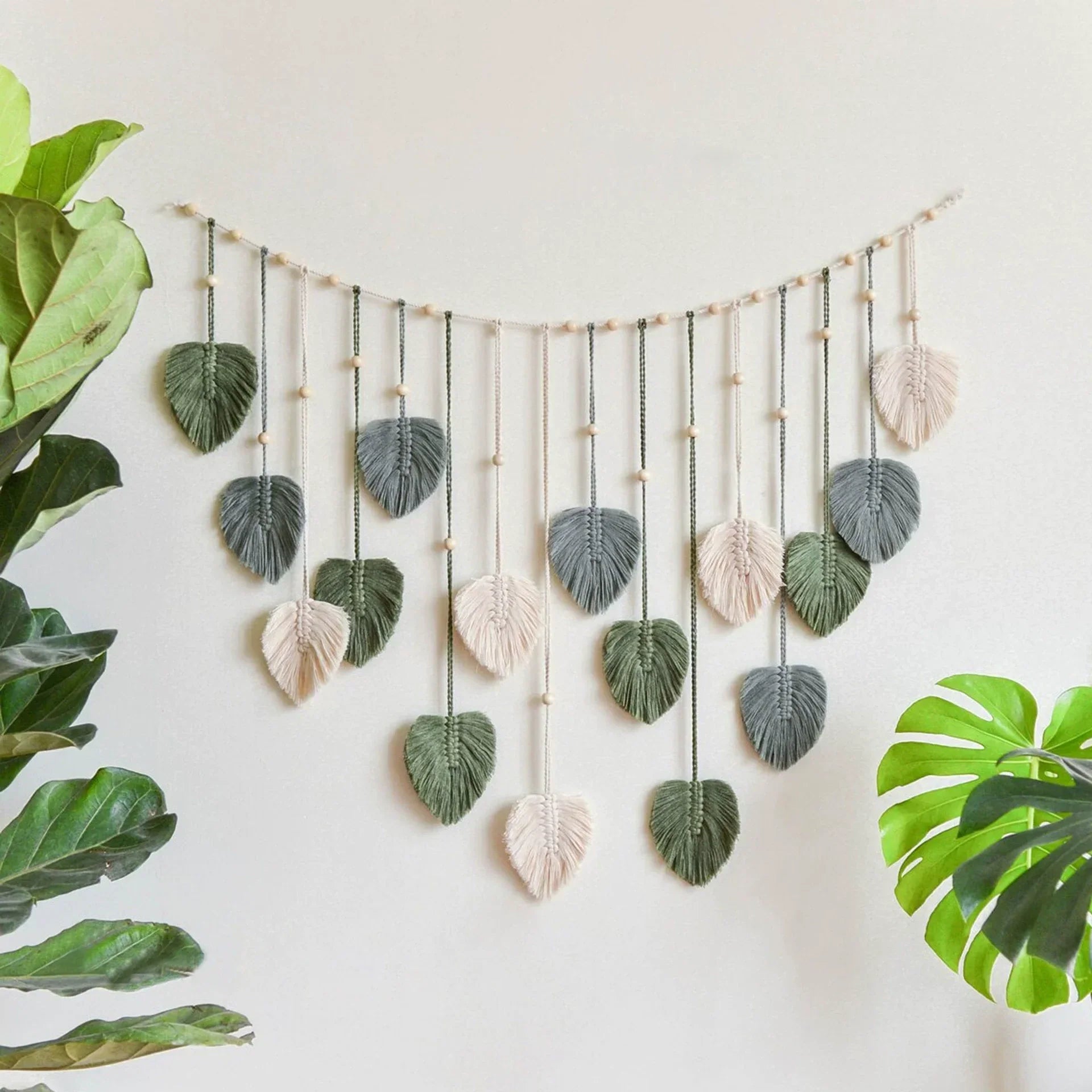 DecorBites™ boho style handmade tapestry with green and cream macrame leaves on wood dowel for living room decor