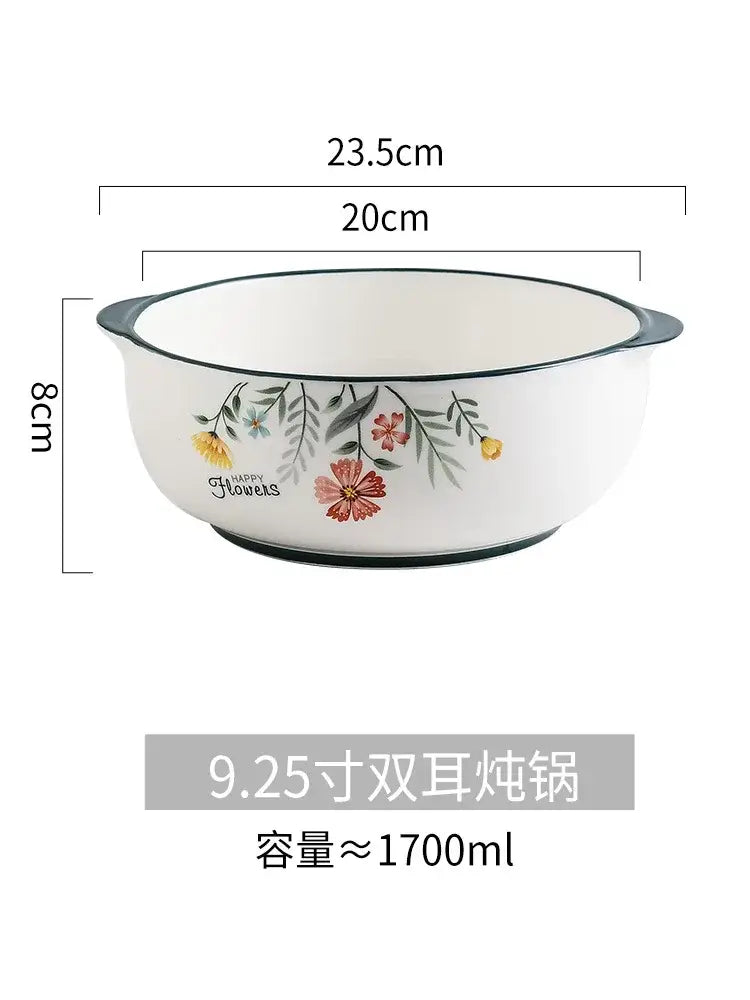 White ceramic bone china rice noodles bowl with black rim handles and pink yellow floral pattern by DecorBites