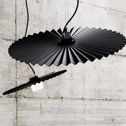 Black fan-shaped pendant light with metallic finish and segmented design from decorbites boomerang wood chandeliers