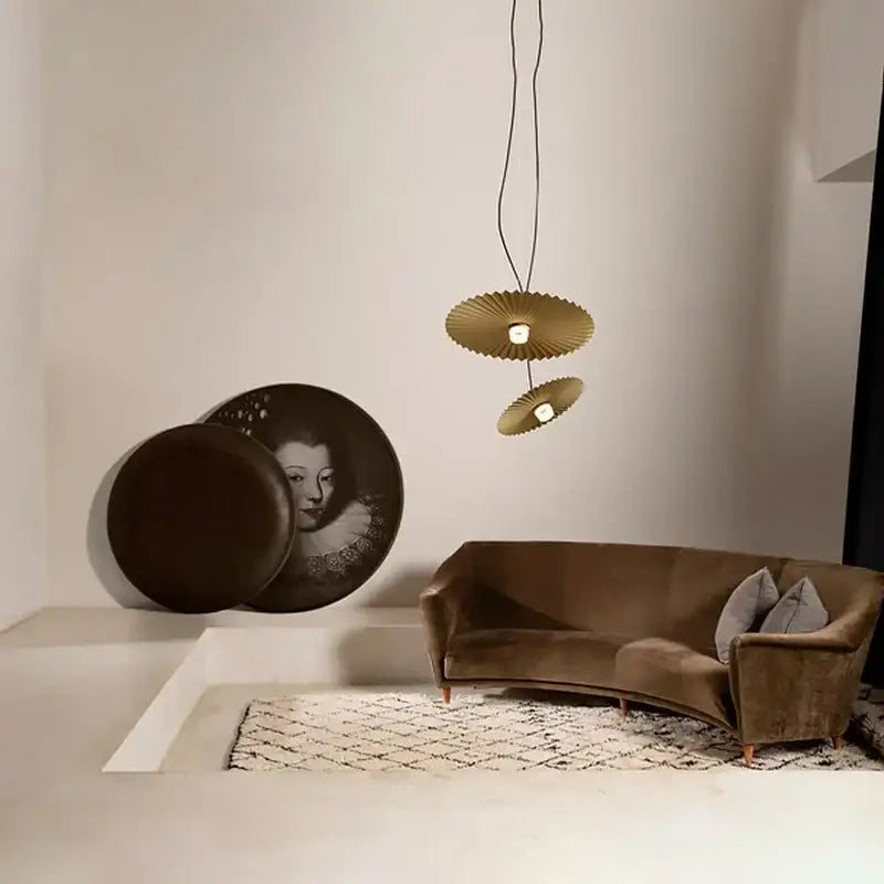Gold-toned fan-shaped pendant lights with modern design complement decorbites boomerang wood black and cream pleated fan lamp